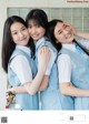 A group of three young women in school uniforms posing for a picture.