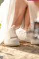 A close up of a person tying up a pair of shoes.