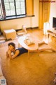 A woman laying on the floor in a living room.