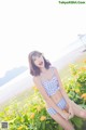 A woman in a blue and white checkered bathing suit posing for a picture.